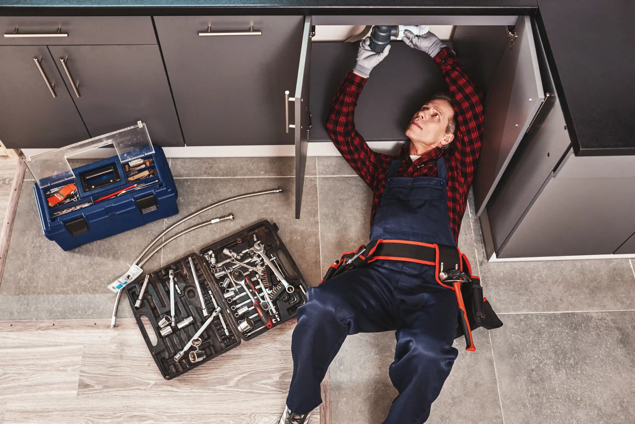 tools-case-top-view-of-seniour-plumber-repairing
